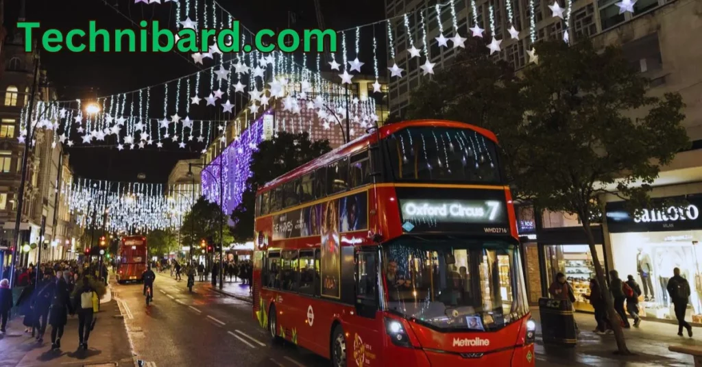 a double decker bus on a street with lights and buildings