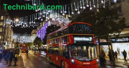 a double decker bus on a street with lights and buildings